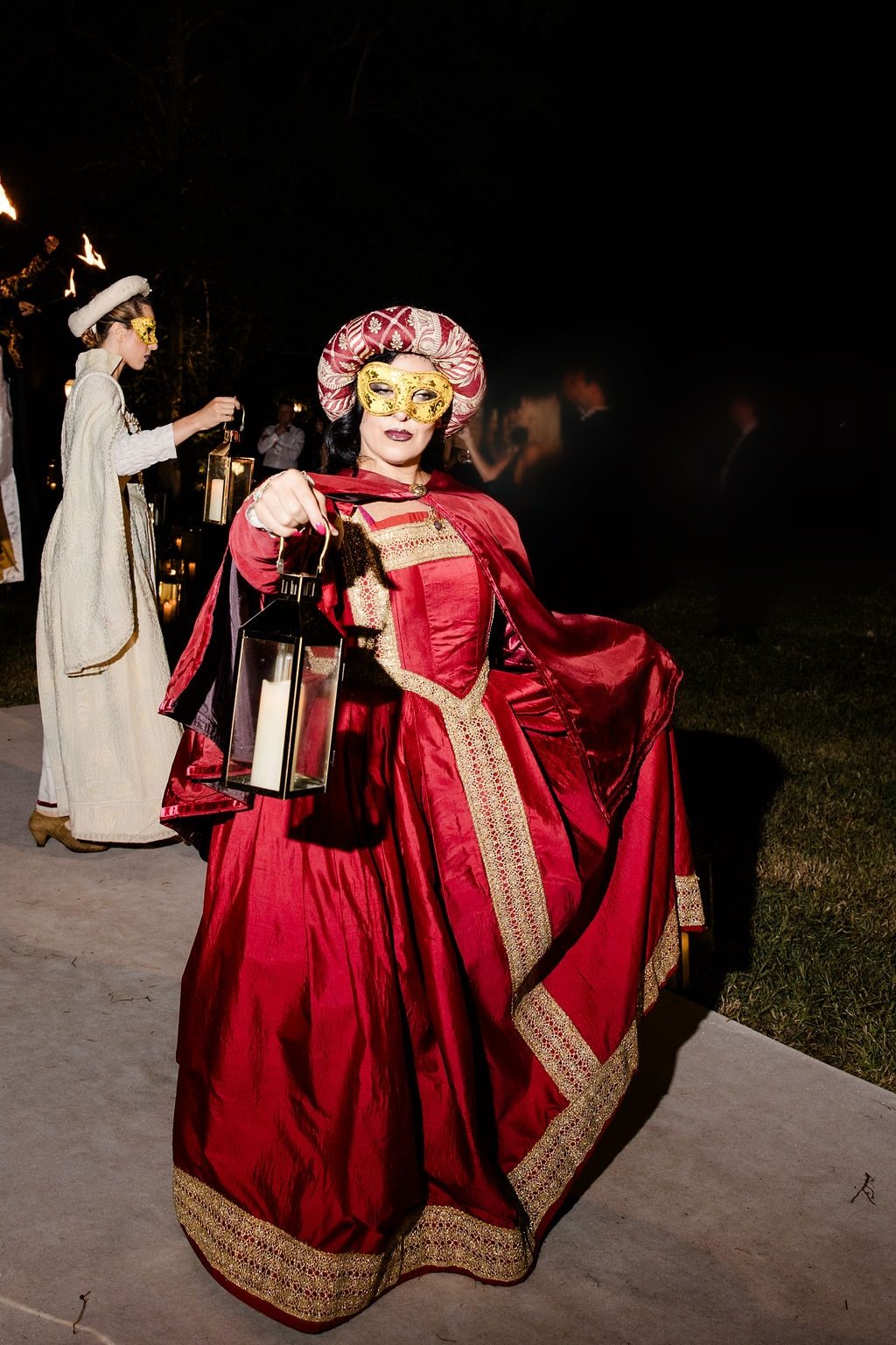 Masked performers carrying lanterns
